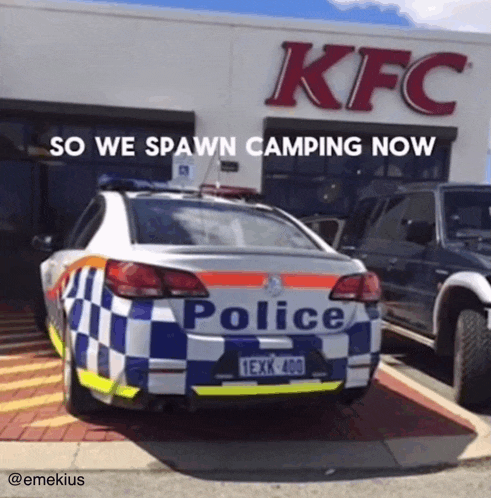 a police car is parked outside of a kfc restaurant