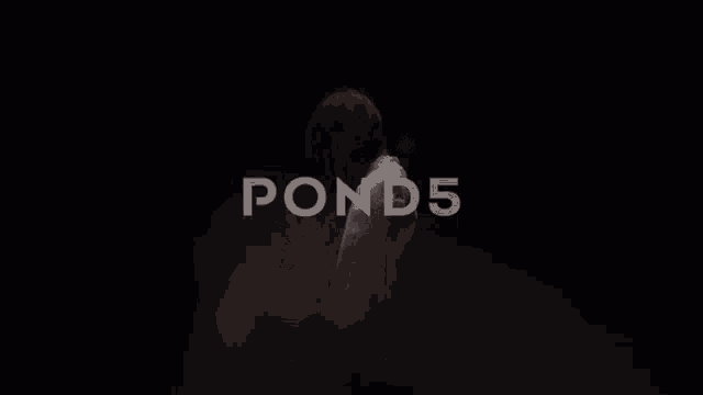 a woman in a white shirt is standing in a dark room with the words pond 5 behind her