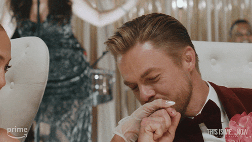 a man is kissing a woman 's hand in a prime video