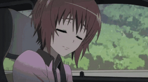 a girl in a pink shirt is sleeping in the back seat of a car .