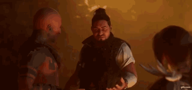 a group of men are standing next to each other in a dark room talking to each other .