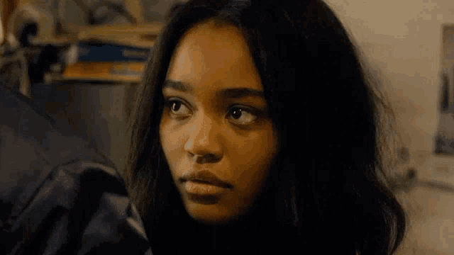 a close up of a young woman looking at the camera .