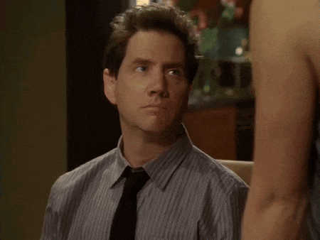 a man in a striped shirt and tie looks to the side