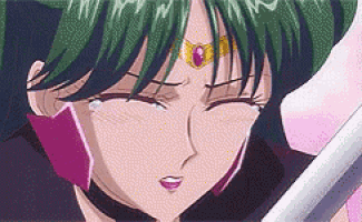a close up of a cartoon character with green hair holding a sword and crying .