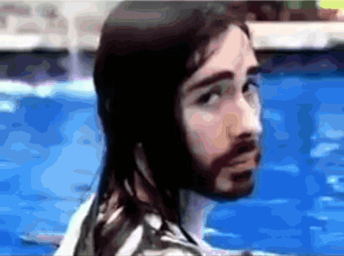 a man with long hair and a beard in a pool