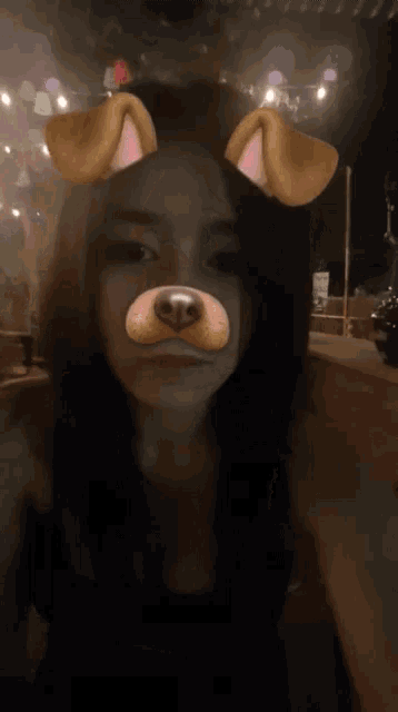a girl wearing a dog face mask with her tongue out