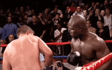a boxer with the number 12 on his shirt is fighting another boxer