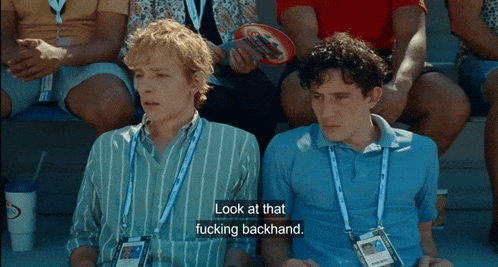 two men are sitting next to each other and one of them is saying look at that fucking backhand