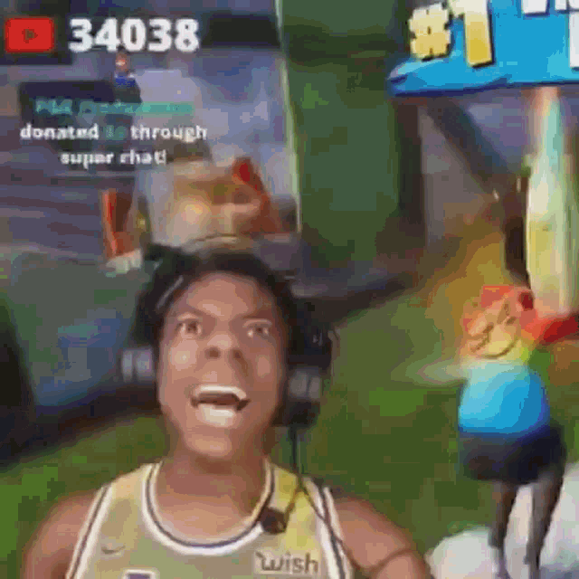 a man wearing headphones is playing a video game and screaming .