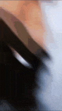 a blurry picture of a person 's face with a shadow of a hand