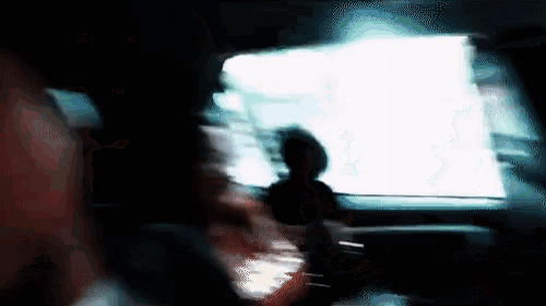 a blurry picture of a person looking out of a car window