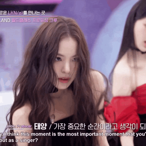 a woman with long hair is being interviewed by a producer