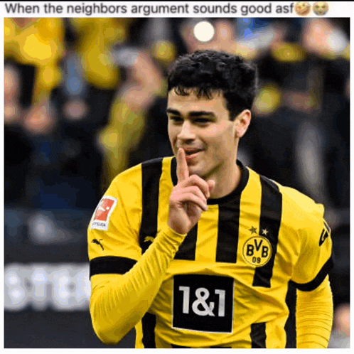 a soccer player wearing a yellow and black striped shirt with the number 1 & 1 on it