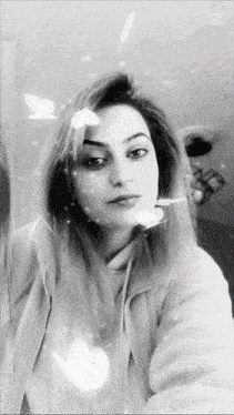 a black and white photo of a woman with the letter m visible