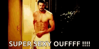 a shirtless man in a towel is standing in a doorway and says `` super sexy oufff !!! ''