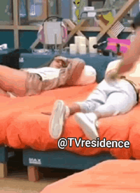 a couple of people laying on a bed with the words @tvresidence above them
