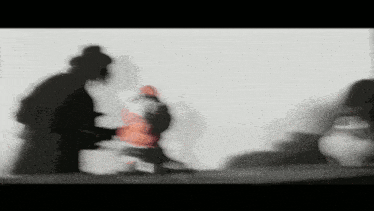 a blurry picture of a woman holding a baby