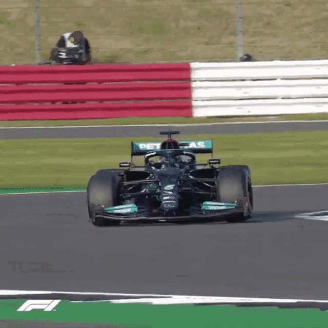 a race car with the word petronas on the side of it