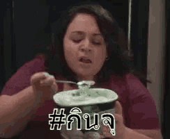 a woman is eating ice cream out of a cup .