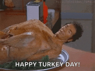 a man is laying on top of a turkey on a plate and says `` happy turkey day '' .