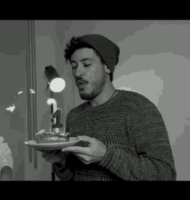 a man is blowing out a candle on a cake that has the number four on it