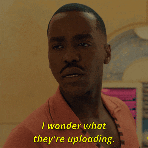 a close up of a man 's face with the words i wonder what they 're uploading