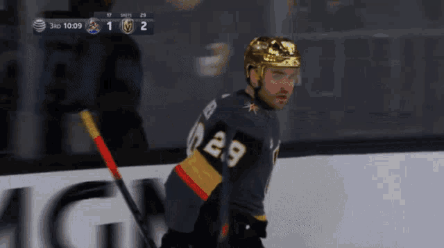 a hockey player with the number 29 on his jersey stands on the ice