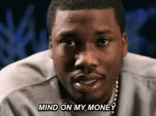 a close up of a man 's face with the words `` mind on my money '' written on it .