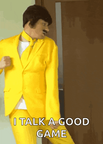 a man in a yellow suit is dancing and says i talk a good game on the bottom