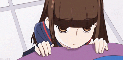 a cartoon girl with a sad look on her face is laying on a purple blanket