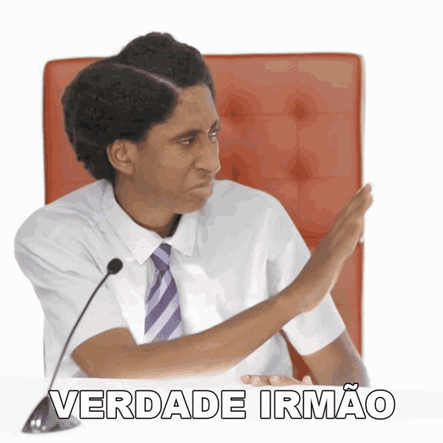 a man in a white shirt and purple tie sitting at a table with the words verdade irmao on the bottom