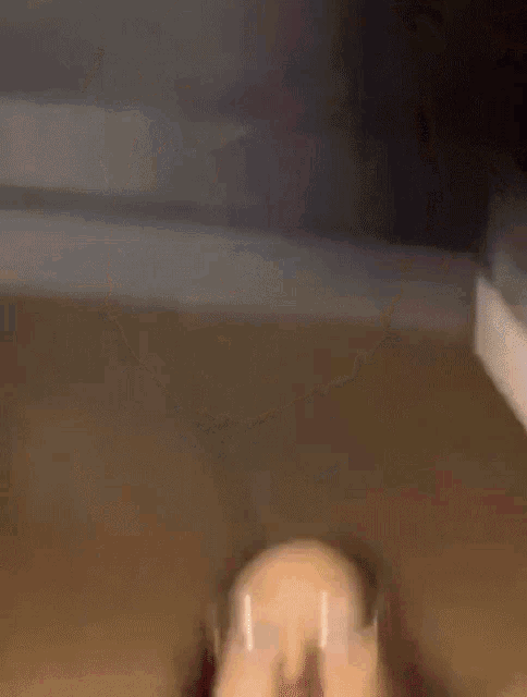 a blurry picture of a person making a face with their mouth open .