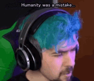 a man with blue hair is wearing headphones and says humanity was a mistake ..