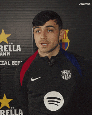 a man stands in front of a sign that says rella