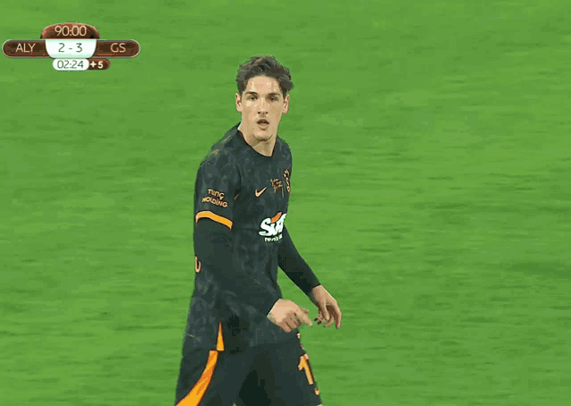 a man in a sixt rent a car jersey stands on a soccer field