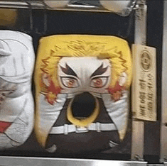a pillow with a face on it is sitting on top of a shelf .