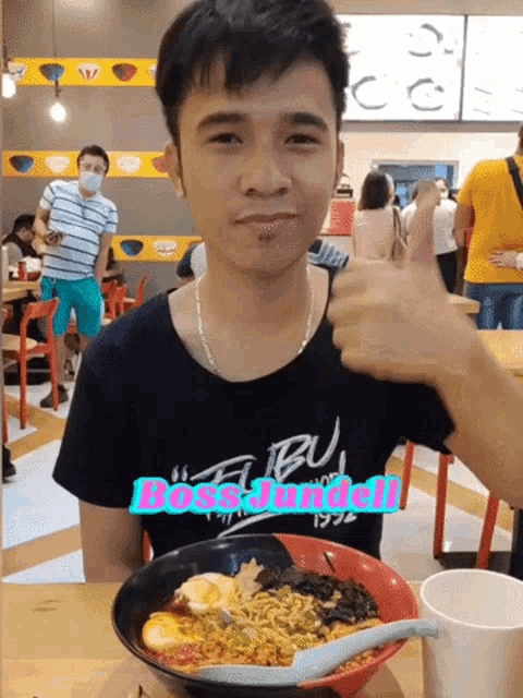 a man giving a thumbs up next to a bowl of ramen with the words boss jundell on the bottom