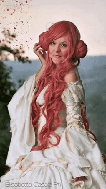 a woman with pink hair is wearing a white dress by elisabetta casale