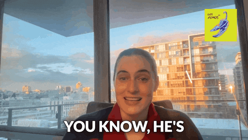 a woman says you know he 's in front of a large window