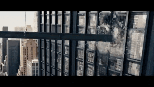 a large building with a lot of windows is being destroyed by a giant robot .