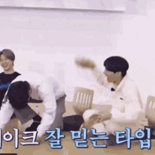 a group of men are playing a game with korean writing on the bottom .