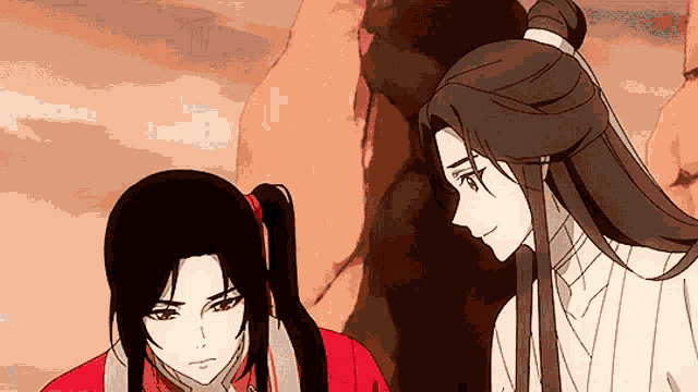 a man and a woman are standing next to each other and looking at each other .