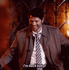 a man in a suit and tie is smiling and saying `` i 'm back baby ! ''