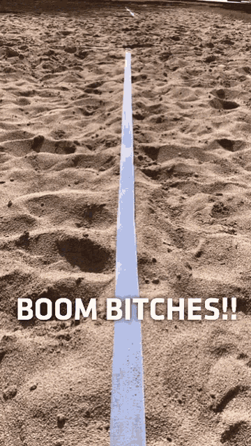a line in the sand with the words boom bitches below it