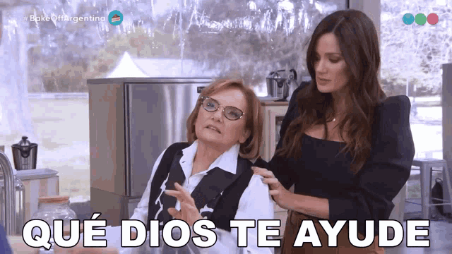 a woman standing next to another woman with the words que dios te ayude written on the bottom