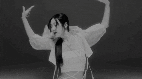 a black and white photo of a woman in a white top