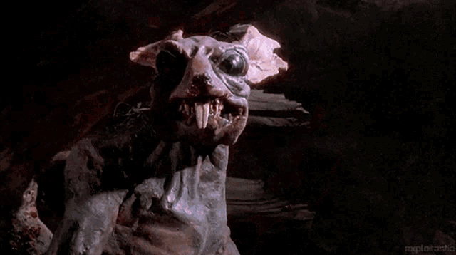 a close up of a very scary monster with a very large mouth and teeth