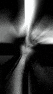 a black and white photo of a light coming out of a hole
