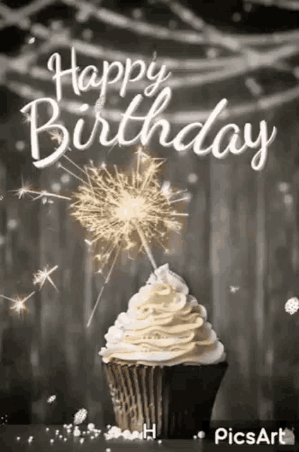 a birthday cupcake with whipped cream and a sparkler on top .