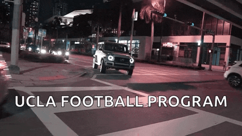 a car is driving down a street with the words ucla football program
